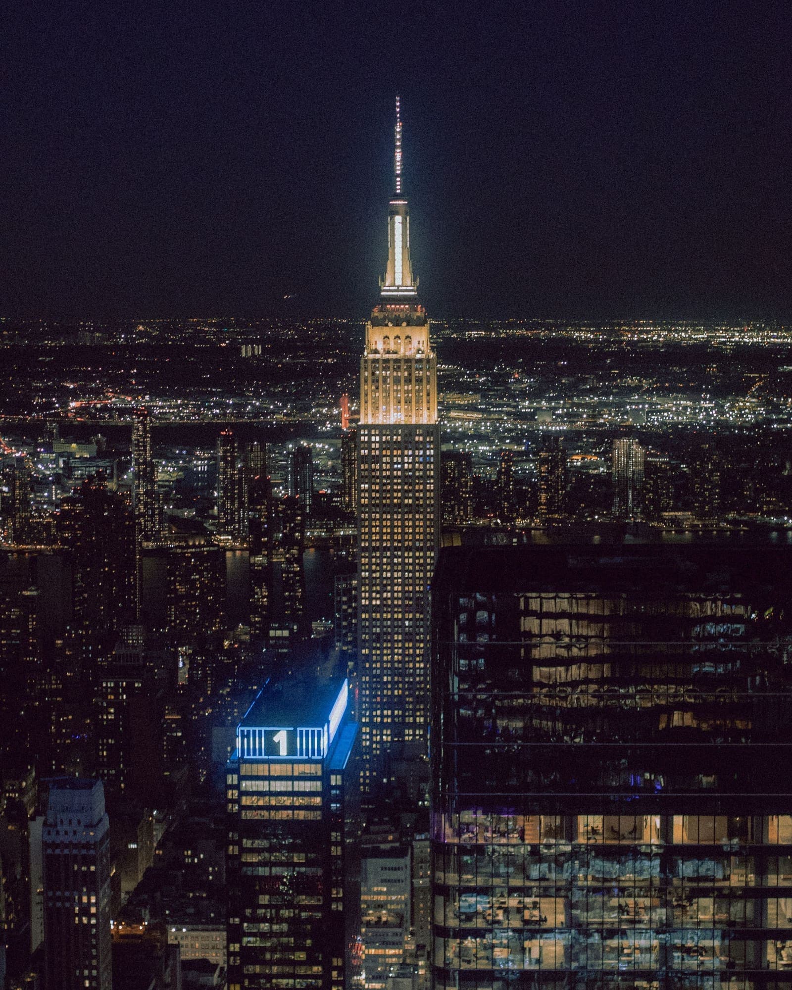 Elevated night view of the Empire State Building above the Manhattan grid