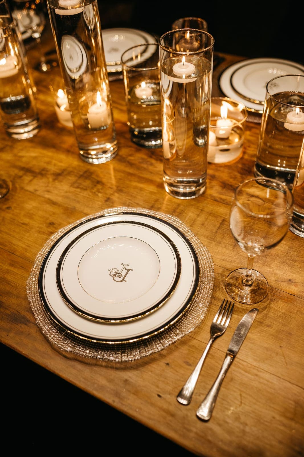 Fine china place setting with crystal glassware on a candlelit table