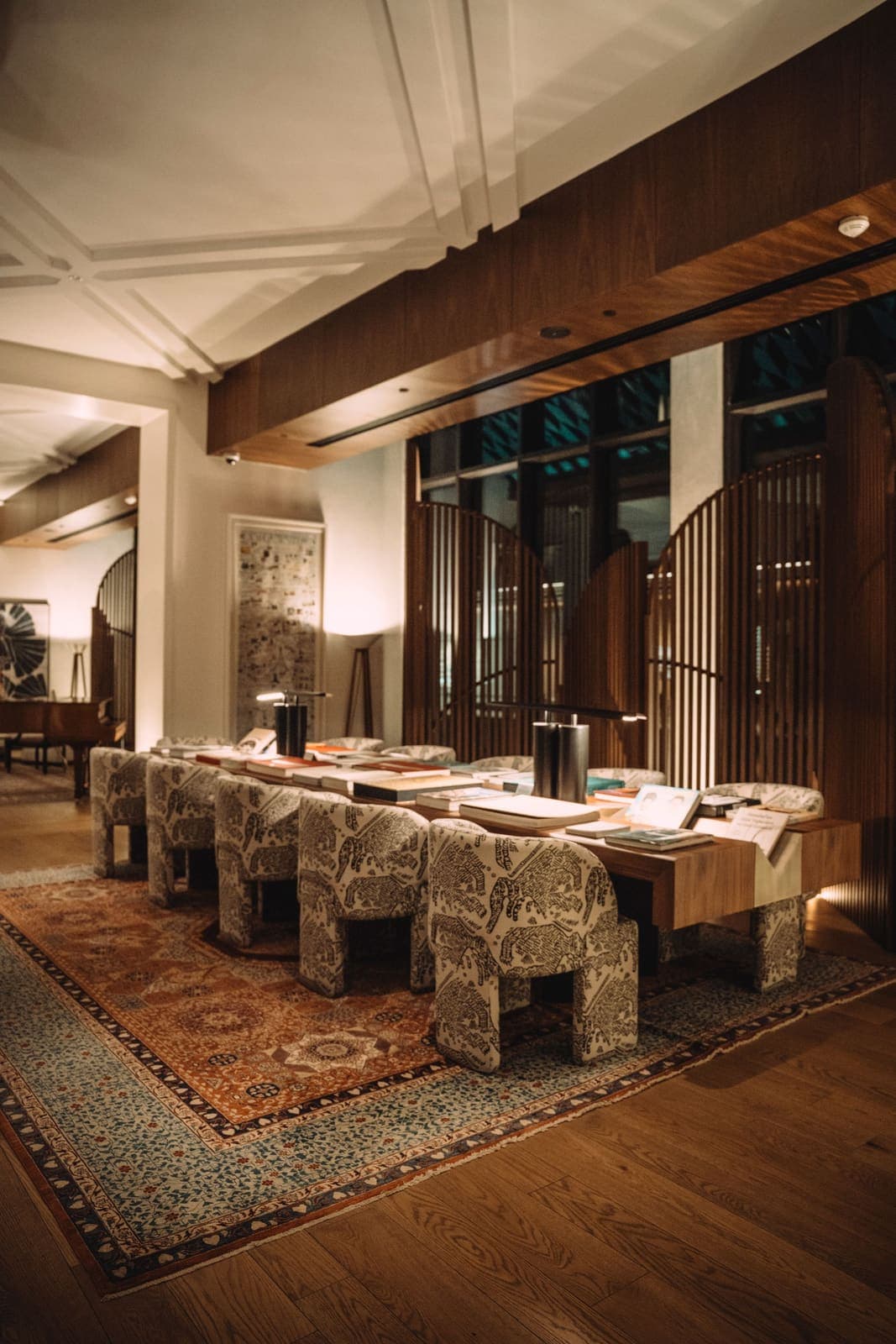 Warmly lit luxury hotel lounge with upholstered seating