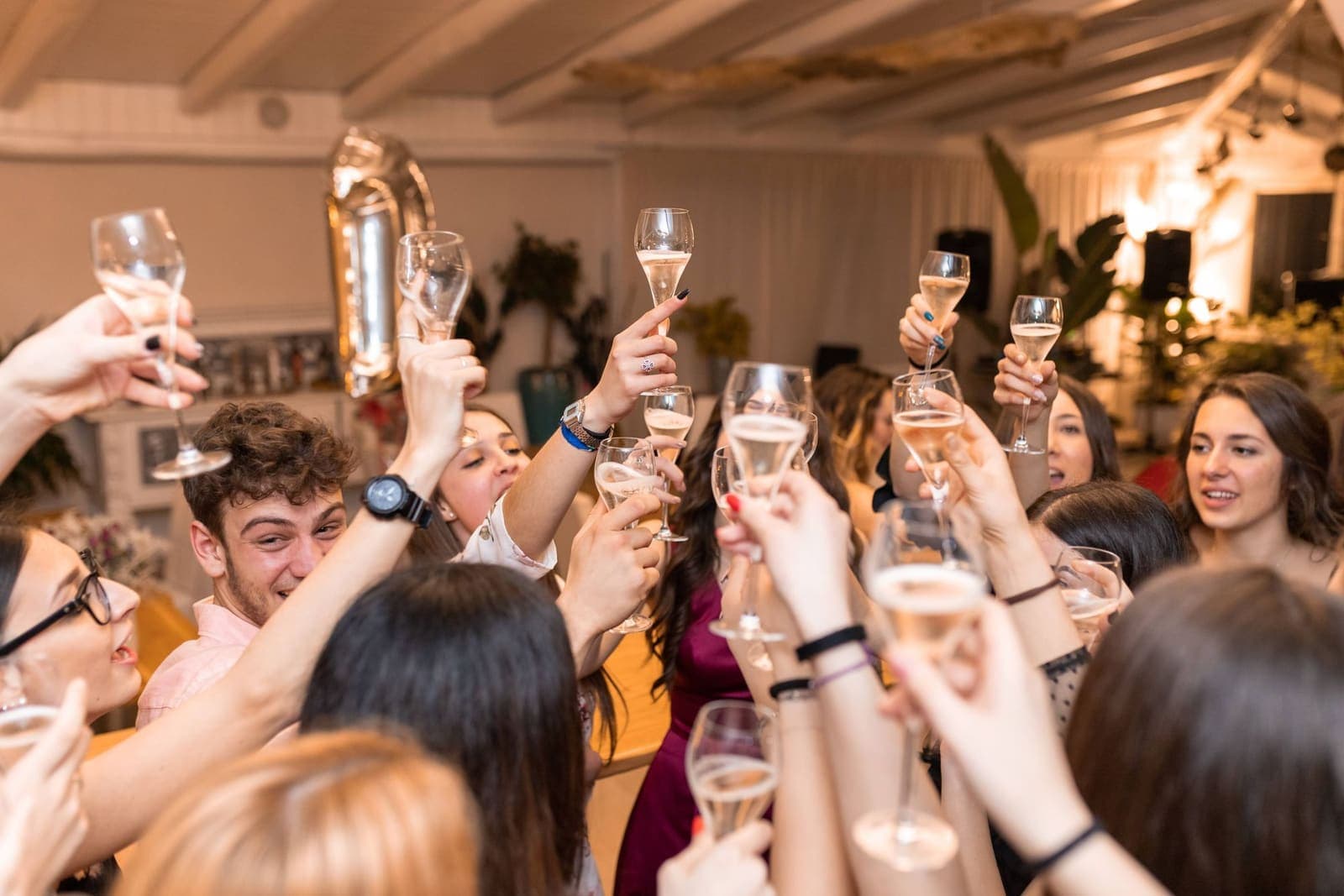 A group of friends clinking champagne glasses at a celebration