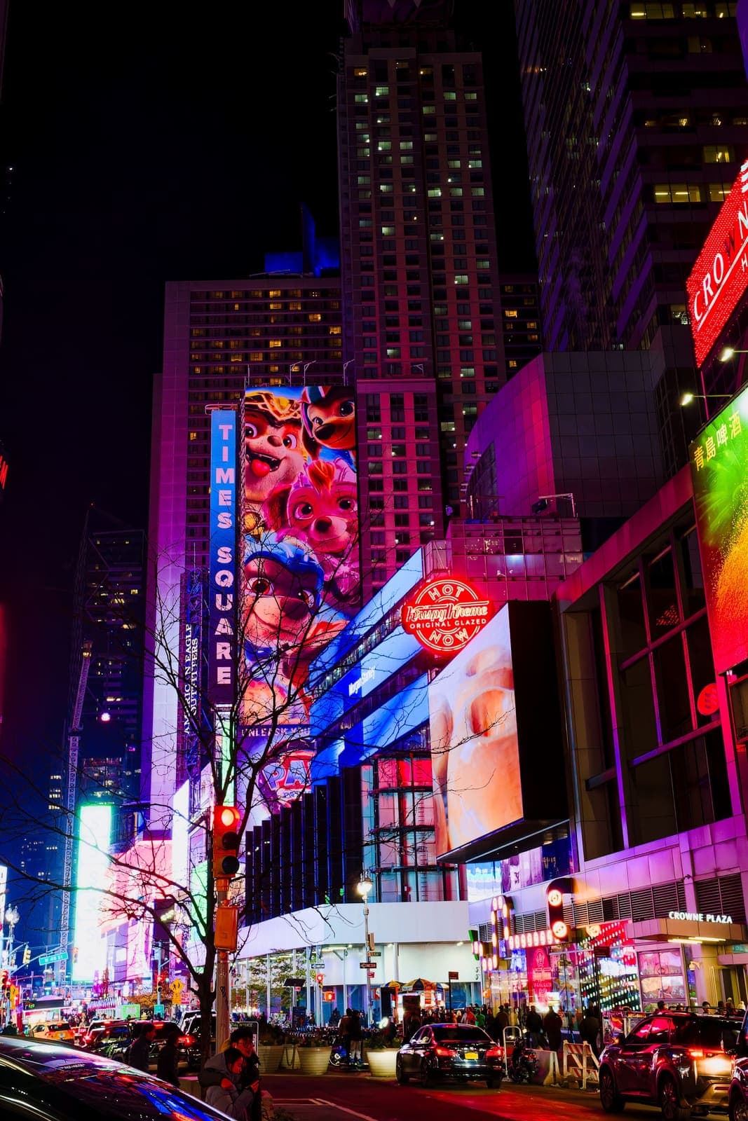 Vertical Times Square sign and colorful neon advertising at night